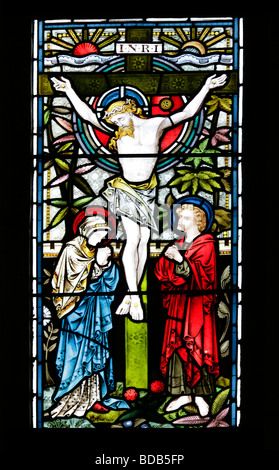 Stained glass window of 1872 by Bell & Almond depicting the crucifixion of Jesus Christ, Earls Barton Church, Northamptonshire, england Stock Photo