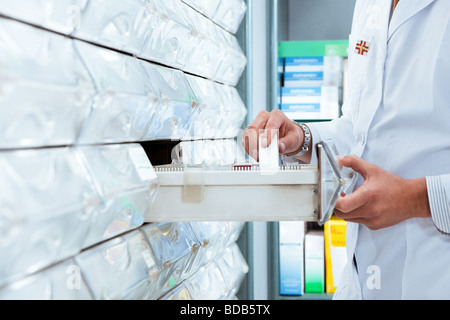 cropped view of pharmacist taking medicine from drawer Copy space Stock Photo