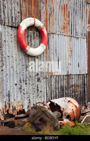 Britain UK Old lifebuoy ring hanging on a corrugated rusty ...