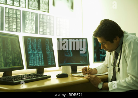 Male doctor writing on a clipboard Stock Photo