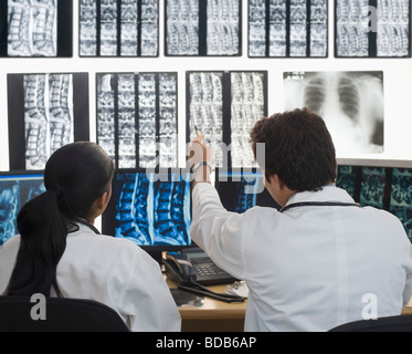 Female doctor with a male doctor examining an X-Ray report Stock Photo