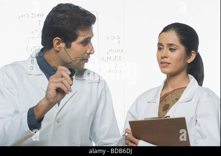 Scientists at work on a problem Stock Photo