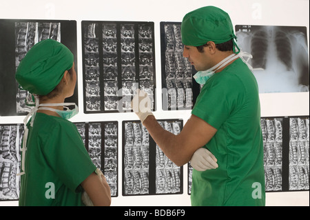 Female surgeon with a male surgeon examining an X-Ray report Stock Photo