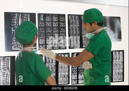 Female surgeon with a male surgeon examining an X-Ray report Stock Photo