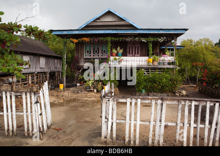 Indonesia Sulawesi Kaledupa Island Ambuea village local wooden house with flowers on balcony Stock Photo