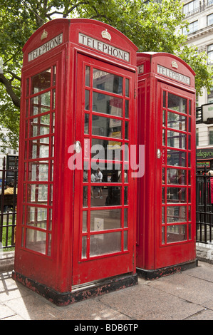 Two traditional British red  public telephone / phone boxes standing side by side in Leicester Square, London, W1 Stock Photo