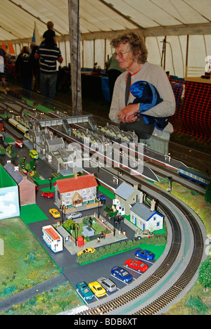 a woman looking at a model railway exhibition at a model fair in cornwall, uk Stock Photo