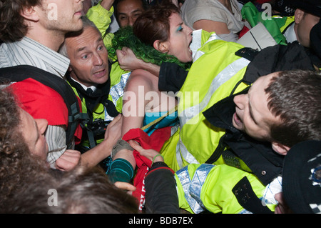 Climate Rush protest on 100th anniversary of Suffragette rush on Parliament - struggles at the door of Parliament Stock Photo