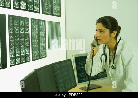Female doctor talking on a phone Stock Photo