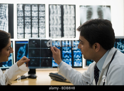 Doctors examining X-Ray report Stock Photo