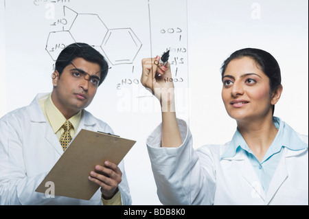 Scientists at work on a problem Stock Photo