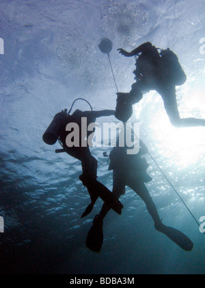 Indonesia Sulawesi Wakatobi National Park underwater scuba divers returning to surface after dive Stock Photo