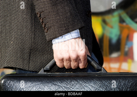 Hand of man with the case - detail Stock Photo