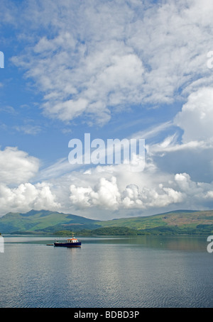 Pleasure or tourist sightseeing boat on Loch Lomond just off a village called Luss, Scotland. Stock Photo