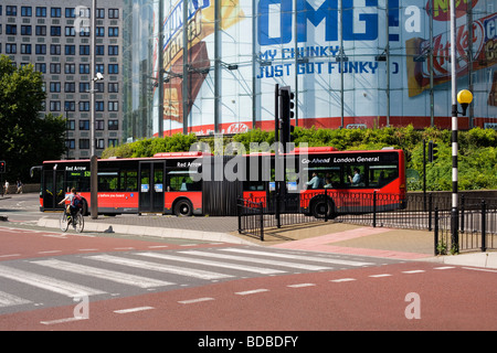 Red London 'Bendy' Bus passes 'IMAX' cinema, Waterloo, London, England, UK, Europe Stock Photo