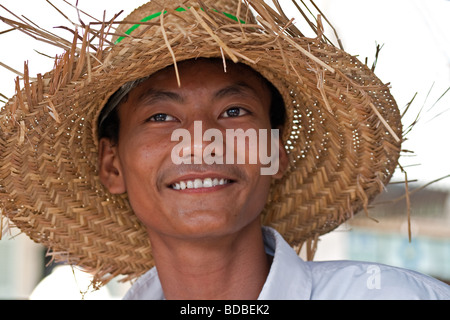 Young Cambodian guy wearing straw hat in Kampong Cham Stock Photo