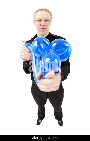 young magic tinkering a balloon animal with balloons Stock Photo