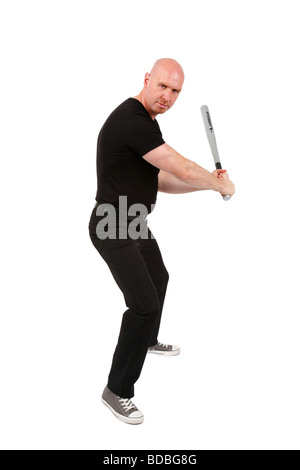 bald headed man with baseball bat in his hands is looking angry into the camera Stock Photo