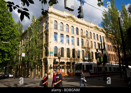 TriMet streetcars running through fareless square in restored Old Town neighborhood of Portland Oregon Stock Photo