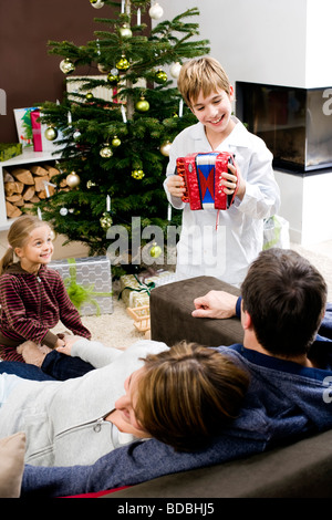 parents listening to their son playing music on christmas morning Stock Photo