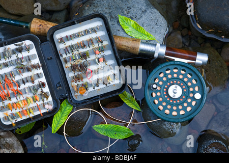 Still life of fly fishing rod, reel, fly box next and fishing bag