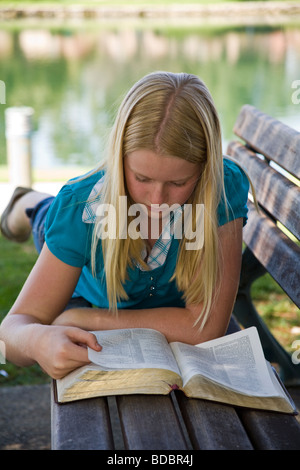11 12 13 year old olds Caucasian Junior high girl reading the Bible meditating reflecting on God's Word. MR Myrleen Pearson Stock Photo