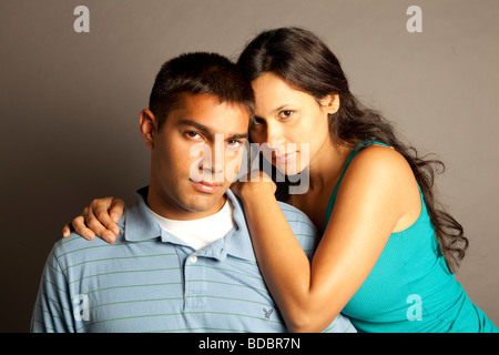 Male female couple posing together in studio in front of a neutral colored seamless. Stock Photo
