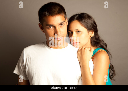 Male female couple posing together in studio in front of a neutral colored seamless. Stock Photo