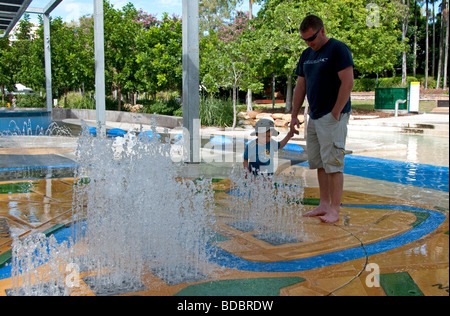 Father and son in the water park at Southbank in Brisbane, Australia Stock Photo