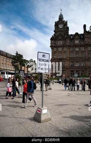 A sign reading 'No trespassing without permission' on Princes Mall, Princes Street (Edinburgh) with the Balmoral Hotel in view Stock Photo