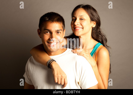 Male female couple posing together in studio in front of a neutral colored seamless. Stock Photo