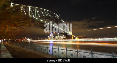 View of Sydney harbour bridge with streaking lights from passing ferry Stock Photo