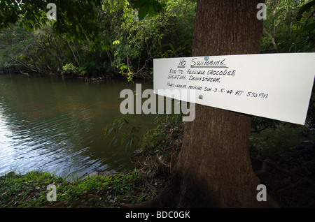 Sign warning that crocodiles have been sighted at Endeavour Falls, formerly a popular freshwater swimming hole, north Queensland Stock Photo