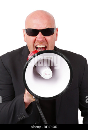 bald headed man shouting into a megaphone Stock Photo