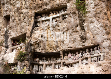 Indonesia Sulawesi Tana Toraja Suaya royal funeral site tau tau on burial cliff face above cave Stock Photo