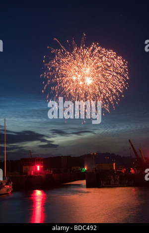 Fireworks on Bastille Day, 14th July, over the harbour and sea lock at Paimpol, Brittany, Northern France. Stock Photo