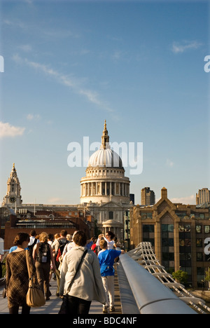 People crossing Millennium Bridge and St Paul's Cathedral in background London England UK Stock Photo