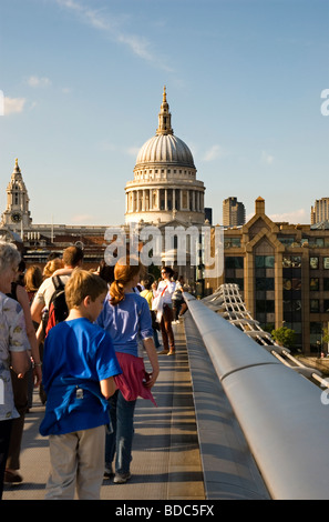 People crossing Millennium Bridge and St Paul's Cathedral in background  London  England UK Stock Photo
