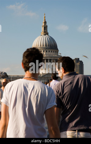 People crossing Millennium Bridge and St Paul's Cathedral in background  London England UK Stock Photo