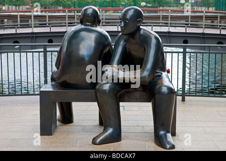Two men on a bench by Giles Penny South Colonnade Canary Wharf London Great Britain Saturday July 04 2009 Stock Photo