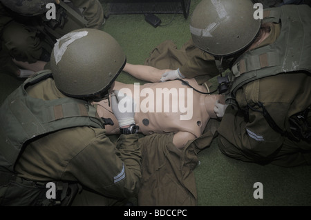 Israeli paramedic soldiers practicing CPR in a plastic resus dummy in the IDF military paramedic training school in Israel Stock Photo