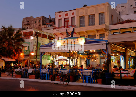 A fine dusk view from Protopapadaki 'Paralia' street to the harbour restaurants of the Naxos Town. Hora, Naxos Island, Cyclades Stock Photo