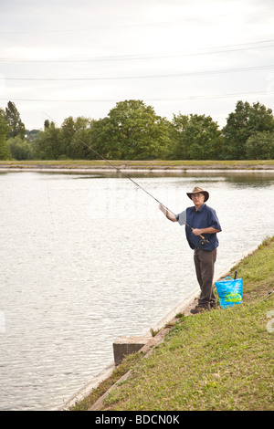 Fisherman fly fishing at Walthamstow fisheries, Walthamstow London England. Stock Photo