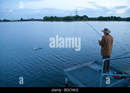 Fisherman fly fishing at Walthamstow fisheries, Walthamstow London England. Stock Photo