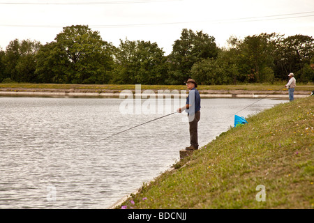 Fisherman fly fishing at Walthamstow fisheries, Walthamstow London England. Stock Photo