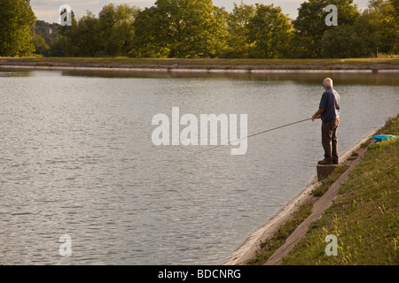 Fisherman fly fishing at Walthamstow fisheries, Walthamstow London England. Stock Photo