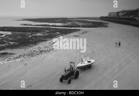 Margate Beach with sailing boats joggers and tractor in black and white 8th June 2008 Stock Photo