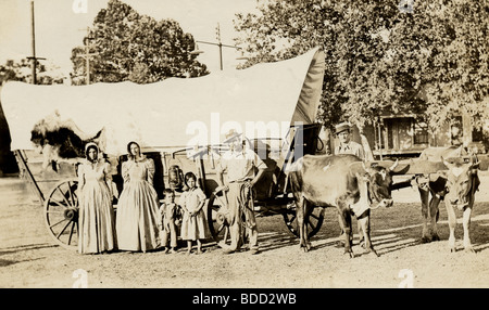 Pioneer Family Posing with Covered Wagon Stock Photo