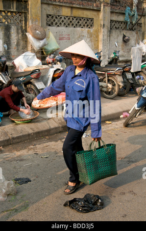 A woman selling dried prawns in the Old Quarter in Hanoi Vietnam Stock Photo
