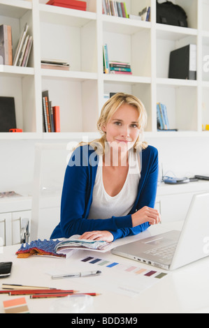 Businesswoman choosing color swatches Stock Photo